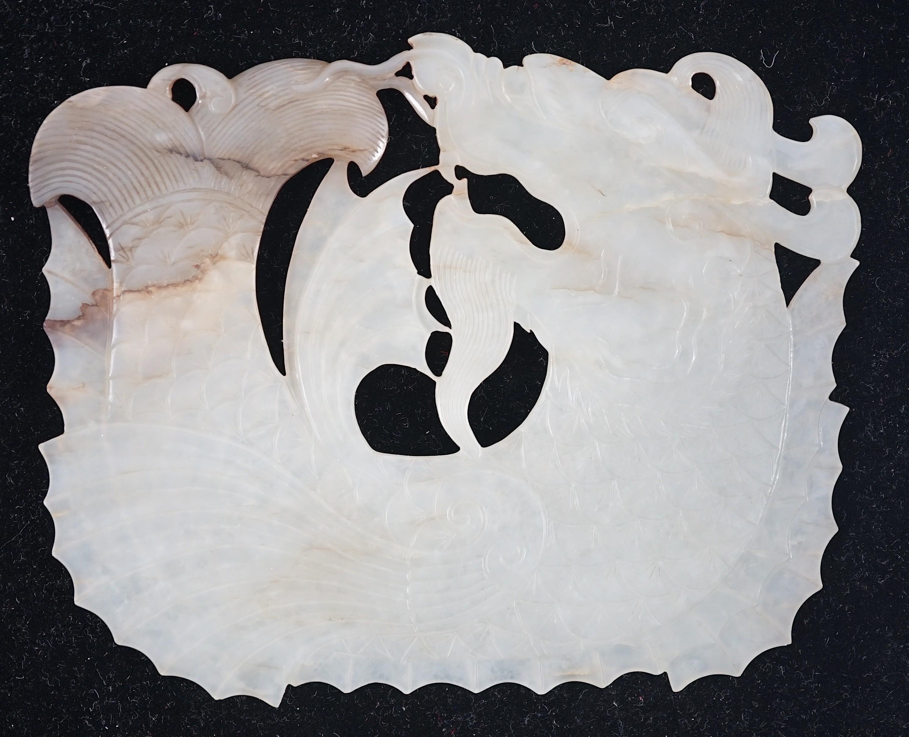 A Chinese late Ming white and grey jade ‘dragon-fish’ plaque, 17th century, 11.7cm wide, 9.3cm high